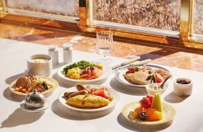 A breakfast setting with various dishes, including eggs, smoked salmon, and fruits, on a marble table with salt and pepper shakers. - Grand Mercure Imperial Palace Seoul Gangnam (Seoul)