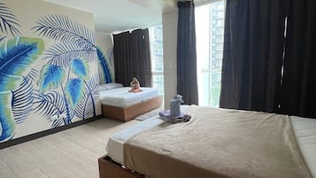 Relax in this stylish room with a large bed, a second bed, and a tropical mural.