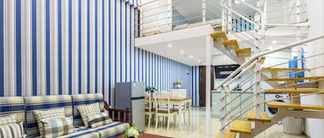 Comfort Loft, 1 Bedroom, City View | Living area | 50-inch LCD TV with cable channels, books