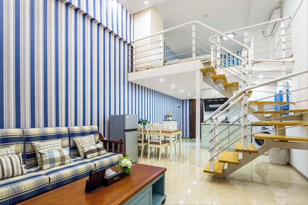 Comfort Loft, 1 Bedroom, City View | Living area | 50-inch LCD TV with cable channels, books