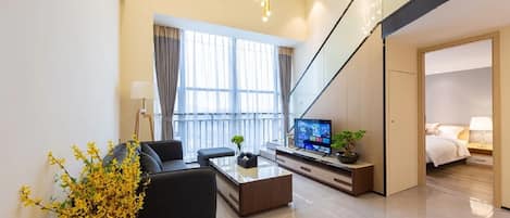 Luxury Loft, 3 Bedrooms, City View | Living area | 50-inch LCD TV with cable channels, books