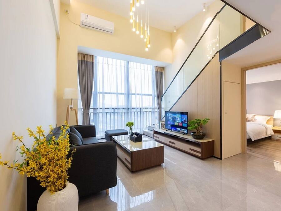 Luxury Loft, 3 Bedrooms, City View | Living area | 50-inch LCD TV with cable channels, books