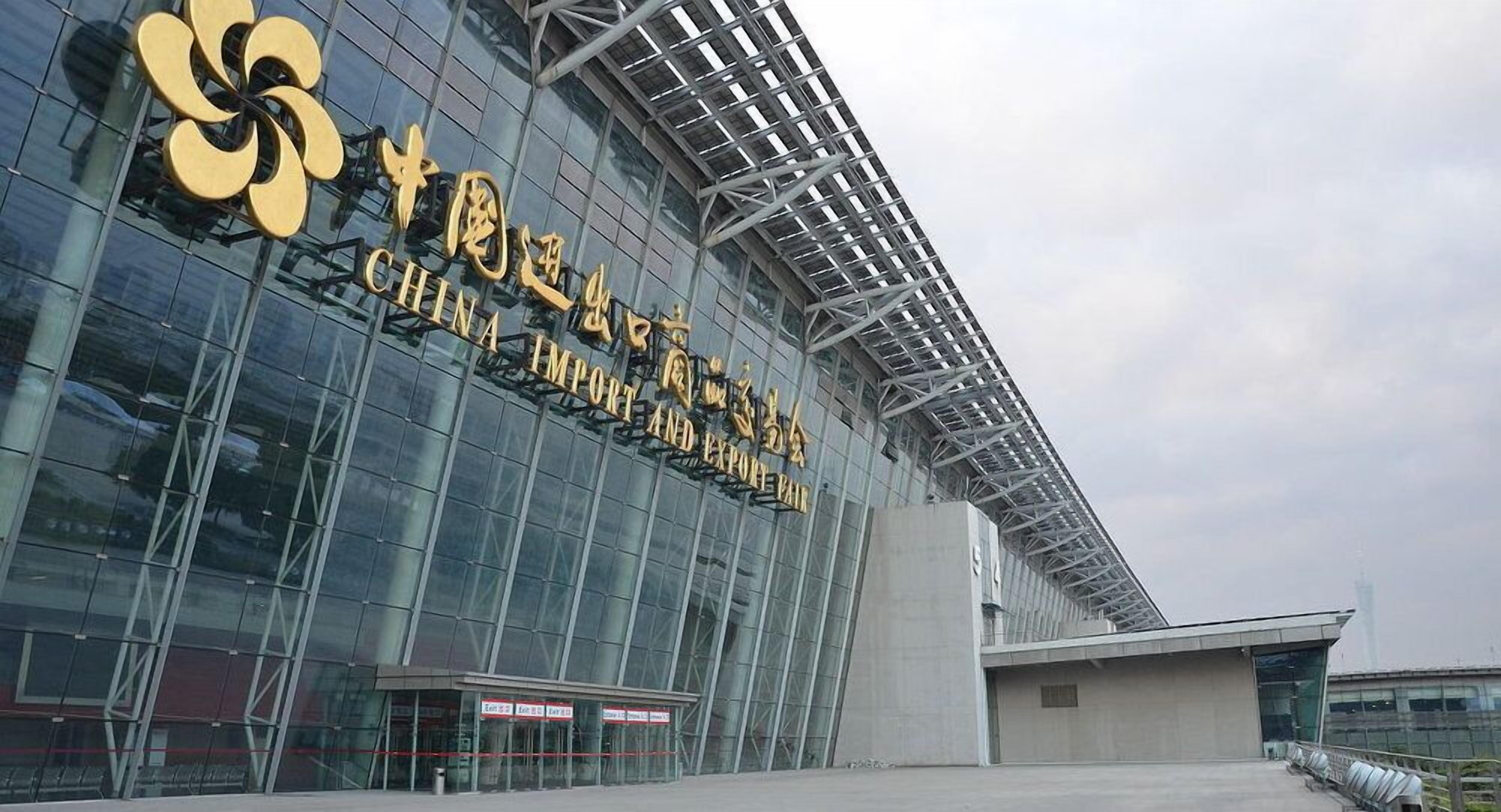 A modern building with large glass windows and a prominent golden logo.