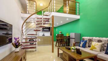 Comfort Loft, 1 Bedroom, City View | Living area | 50-inch LCD TV with cable channels, books