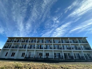 A multi-story building with balconies, likely a hotel or apartment complex.