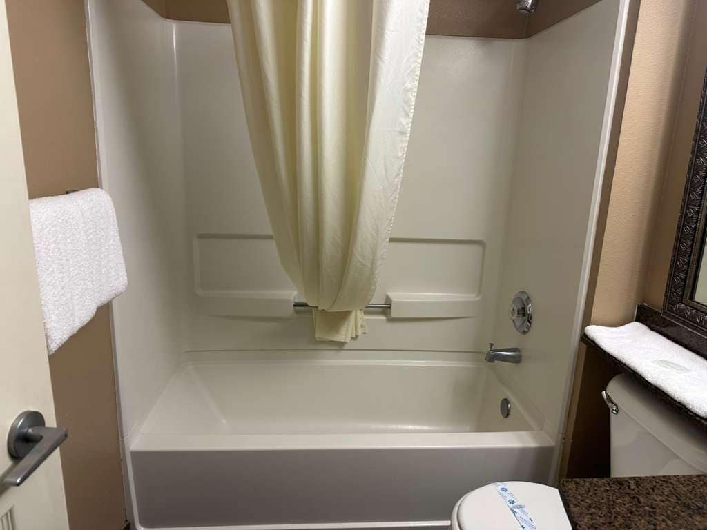 A bathroom with a bathtub, a toilet, and a sink.