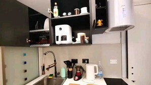A modern kitchen with a stainless steel sink, a built-in oven, and a coffee maker. - CloClo House: Design & Vintage above Metro: Nolo Area (Milano)
