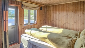 A wooden room with a bed, a window, and a door. - Gorgeous home in Passebekk with kitchen (Passebekk)