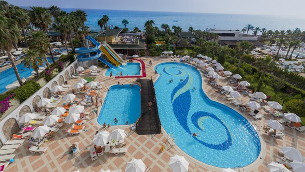A resort with multiple swimming pools, a water slide, and beach views. - Holiday Garden Resort - All inclusive (Alanya)