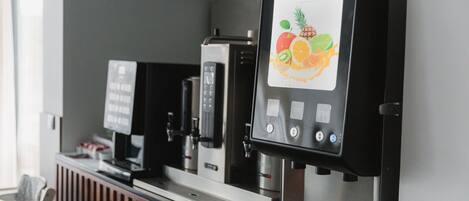 A coffee machine with a fruit-themed display and a control panel.