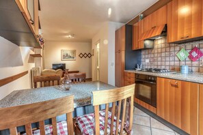 Fridge, microwave, cookware/dishes/utensils, dining tables