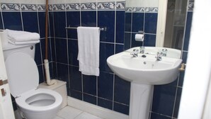 A bathroom with a toilet, sink, and towel rack. - No 13 Townhouse (Kilkenny)