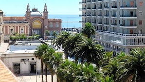 A modern building with balconies and a historic building with a dome in the background. - Bari LandLord 71 (Bari)