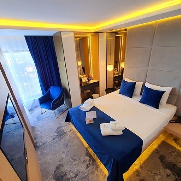 A modern hotel room with a large bed, a desk, a chair, and a mirror. - STEAUA DE MARE - Olimp Resort (Olimp)