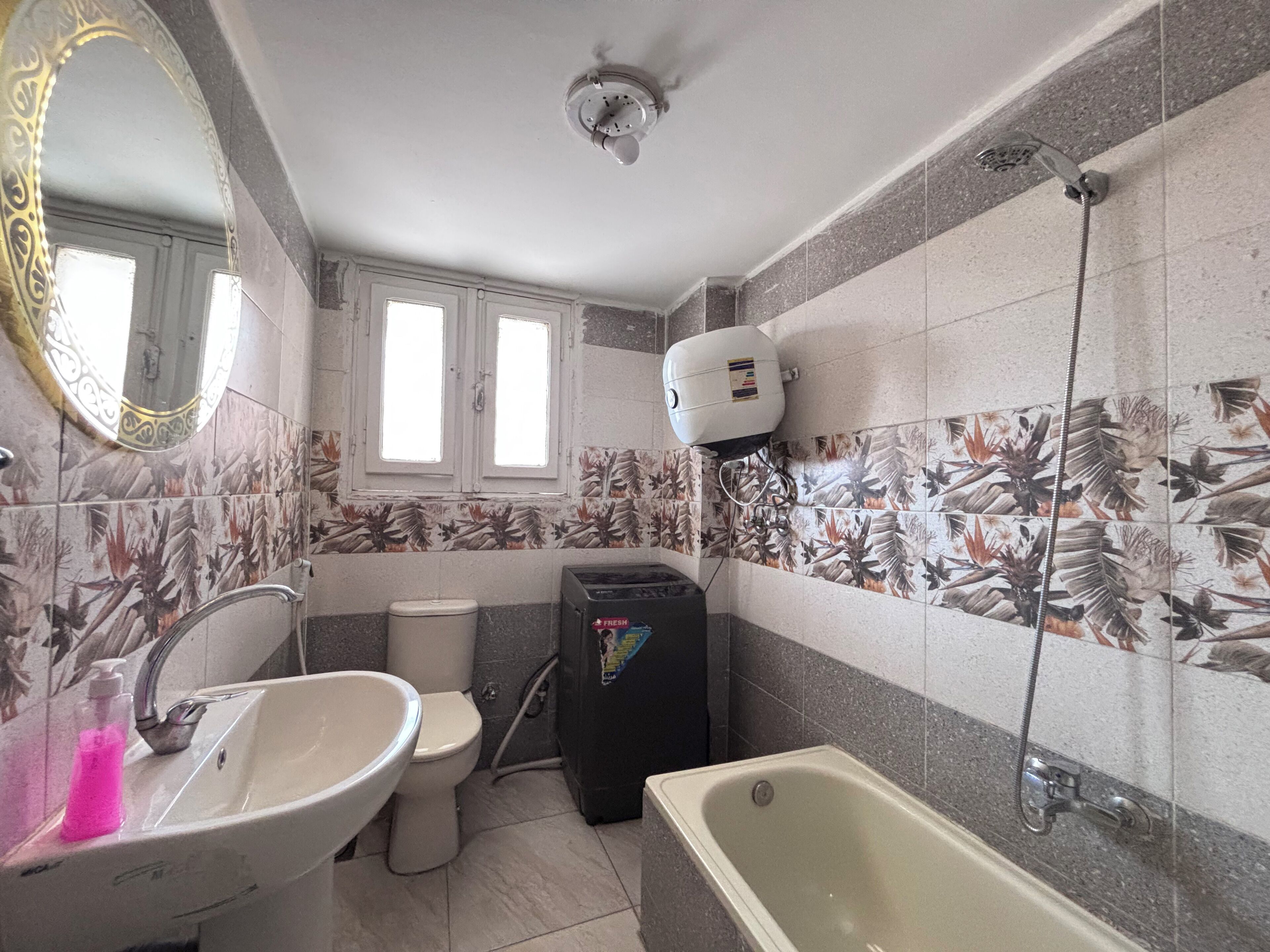 A bathroom with a sink, toilet, and bathtub.