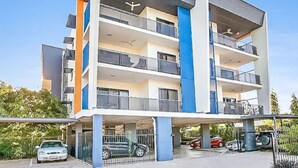 A multi-story residential building with balconies, a covered parking area, and a clear sky. - ZEN Quest · ZEN Quest - 2bed/2bath Near Markets & Foreshore (Nightcliff)