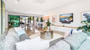A spacious living area with a sofa set, a coffee table, and a dining area visible in the background. - Fred s at Fannie Bay - NT (Fannie Bay)
