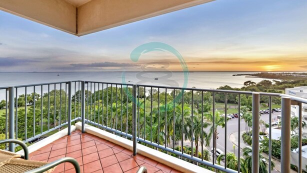 A balcony with a view of the sea and a parking area. - Coastal Splendor Seaview Pool Balcony Dining (Darwin)