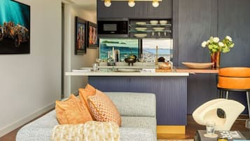 A modern kitchen with a built-in microwave, a coffee machine, and a view of the outdoors.