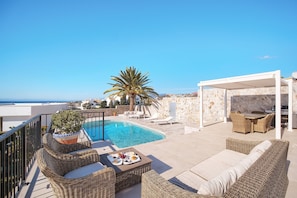 Enjoy breathtaking sea views from our rooftop terrace, featuring a pool, wicker furniture, and a barbecue area.