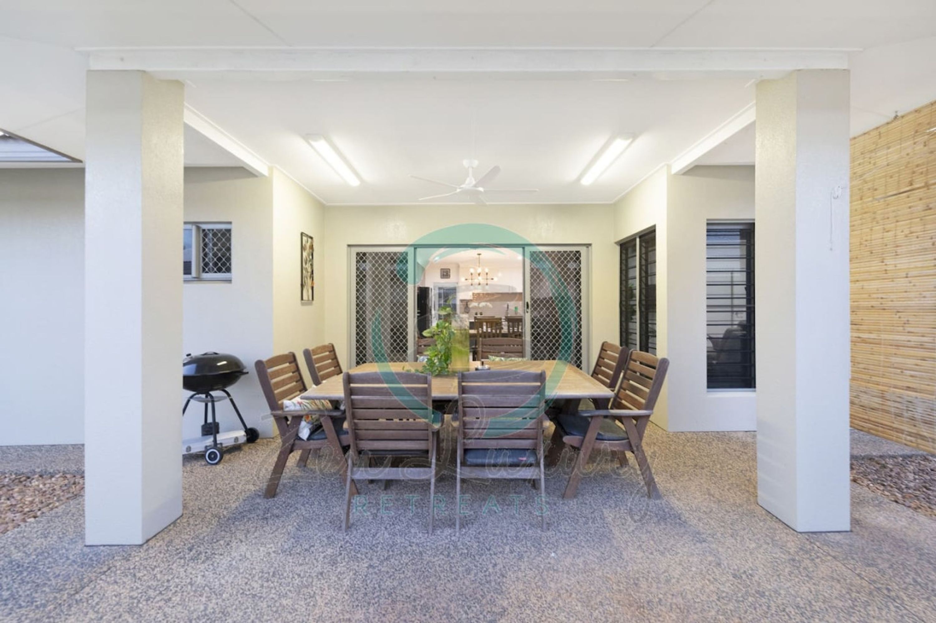 A conference room with a round table, chairs, and a grill.