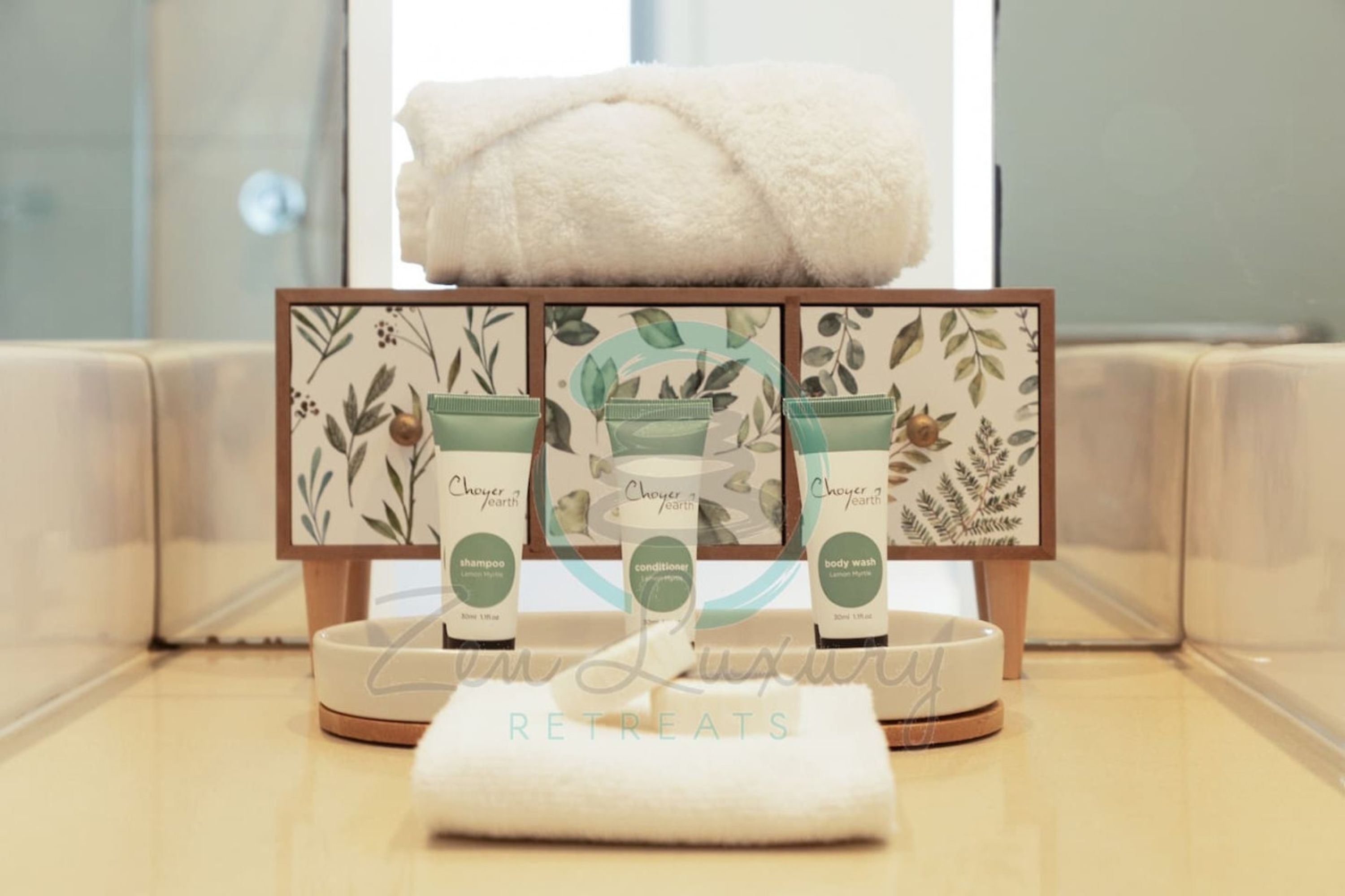 A display of Choyer Earth toiletries on a wooden stand in a hotel setting.