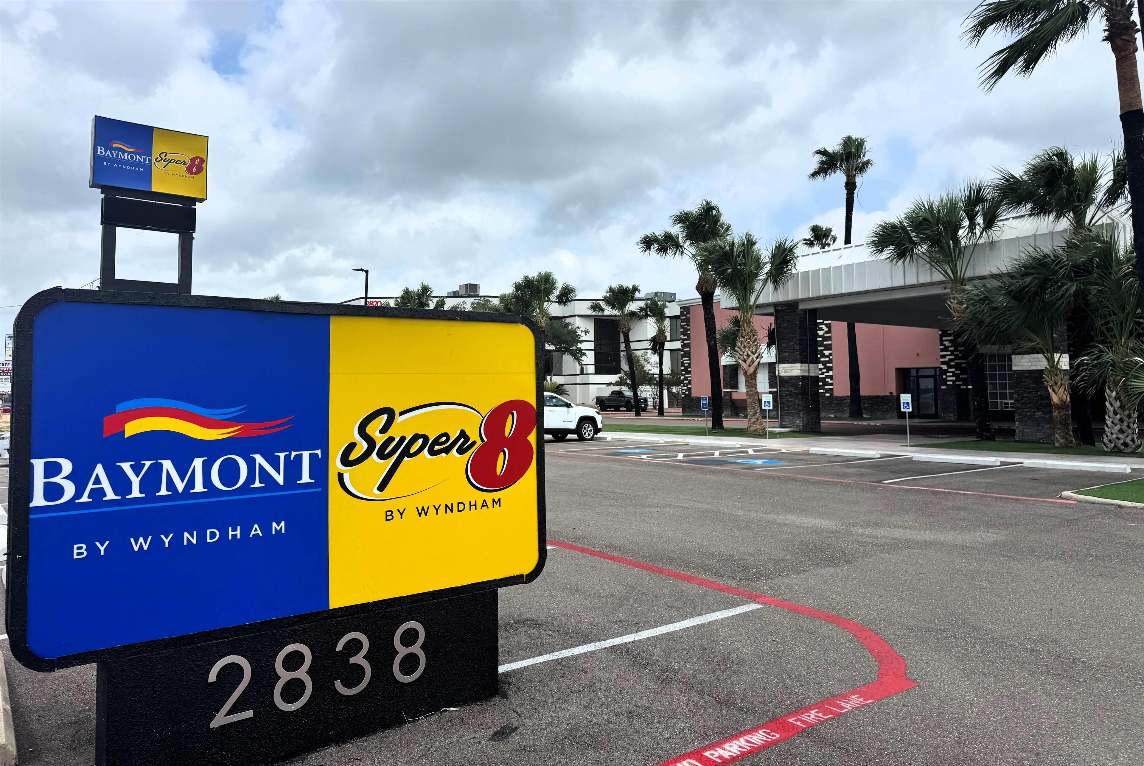 A sign for Baymont by Wyndham, featuring a blue and yellow color scheme, with a number '2838' below.