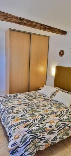 Rest in comfort with a large bed and a spacious wardrobe.