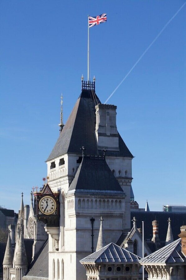 A historic building with a clock tower and a flag. - The Z Hotel City (London)