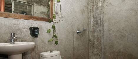 A bathroom with a sink, toilet, and shower.