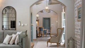 A cozy living room with a sofa, chairs, and a dining area with a table and chairs. - Beautiful Villa Nevia with Private Pool (Ladici)