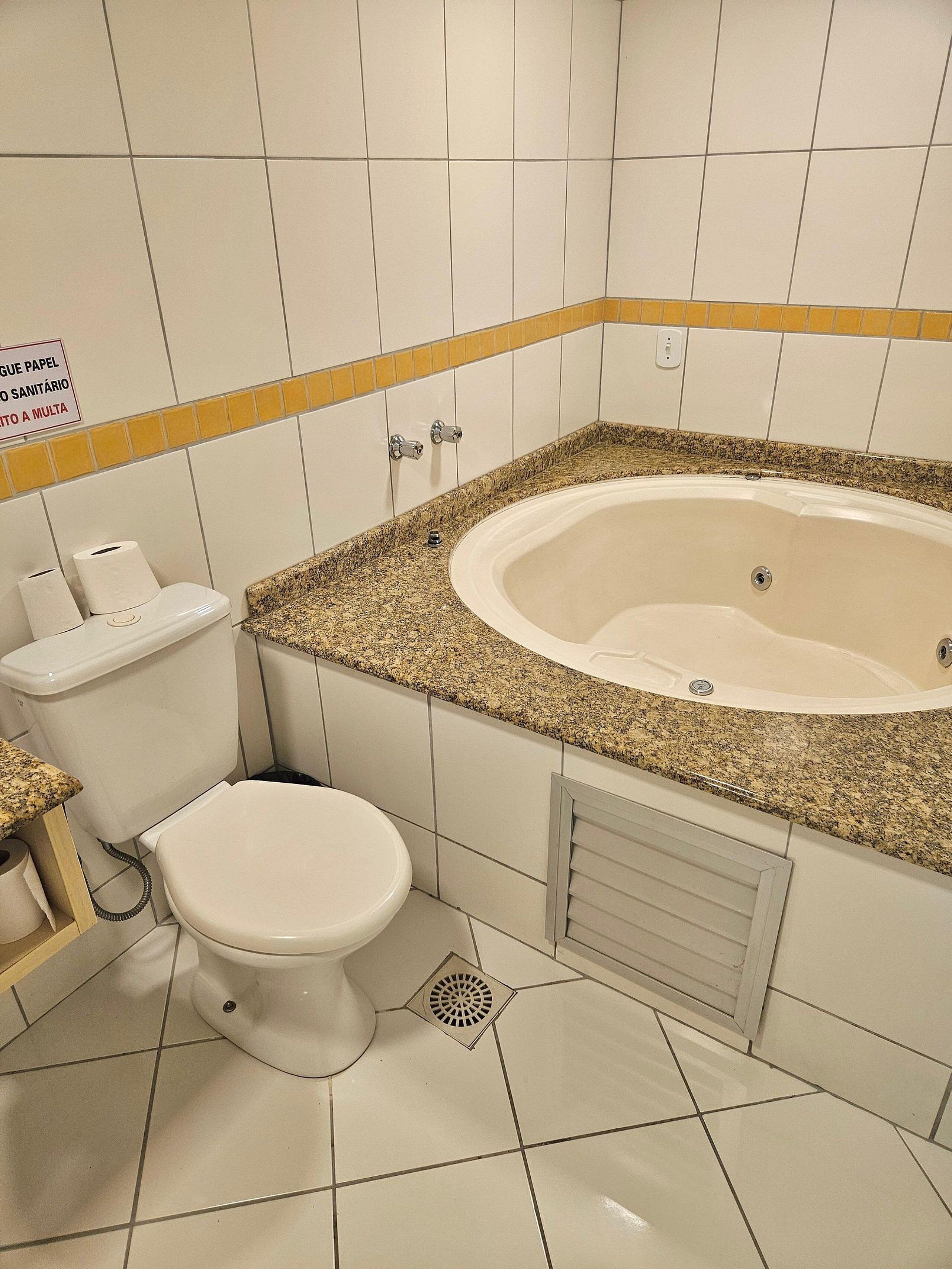 Un baño con inodoro, bidé y bañera.