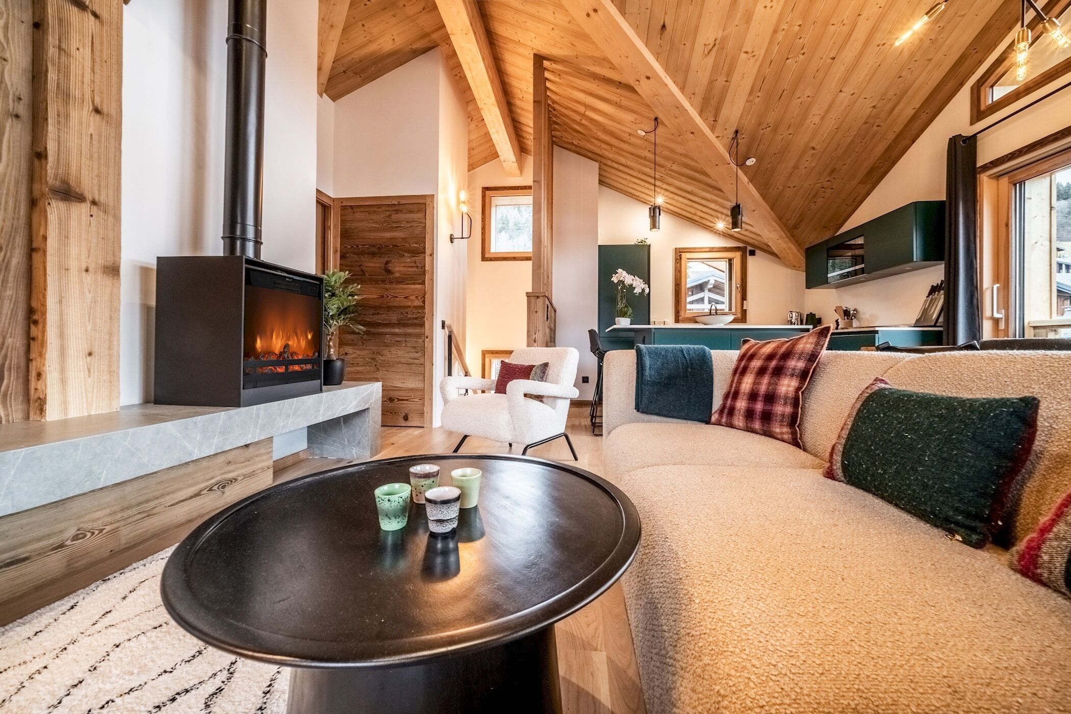 A cozy living room with a fireplace, a sofa, and a coffee table.