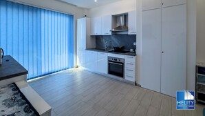 A modern kitchen with white cabinets, a black countertop, and a stainless steel range hood. - [Tropea] Luxury Terrace Sea suite ⭐️⭐️⭐️⭐️⭐️ (Tropea)