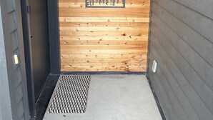 A wooden exterior wall with a number '1445' and a sign reading 'Bootlegger's Nest Anchorage, AK'. - Bootlegger’s Nest
 (Anchorage)