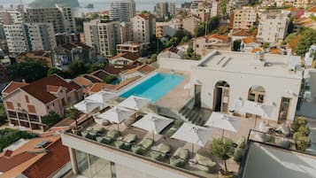 Seasonal outdoor pool, pool umbrellas, pool loungers