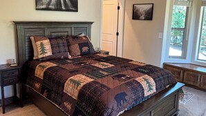 A bedroom with a large bed, a nightstand, a dresser, and a window with curtains. - Pollock Pines - Family get away, 2 miles from Sly Park lake - Near Apple Hill

 (Pollock Pines)