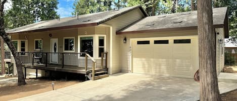A single-story house with a covered porch, a garage, and a driveway.