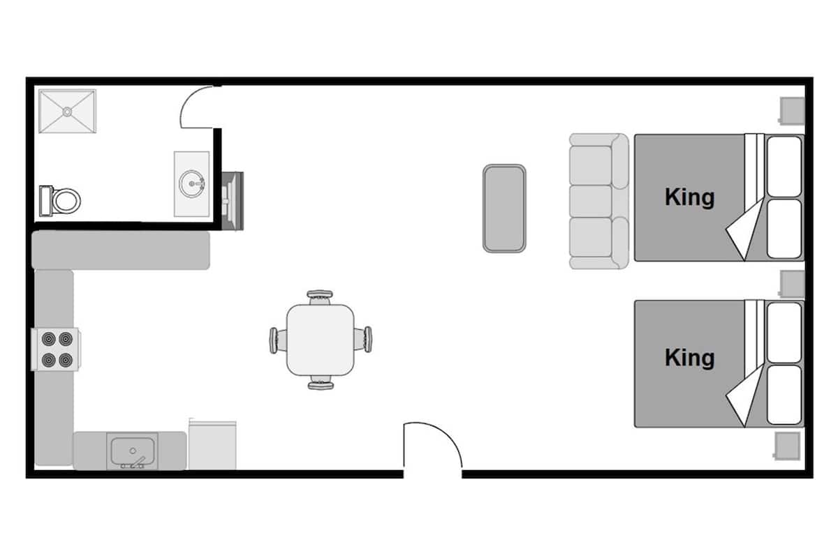 Plan d’étage d’une chambre d’hôtel comprenant un coin cuisine, un espace repas et deux lits « king » séparés.