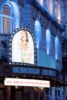 A theater marquee with the name "NOVELLO" and a sign that reads "YOU ALREADY KNOW YOU'RE GONNA LOVE IT!"