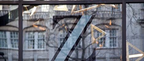 A large window with a geometric design and a visible number '7'.