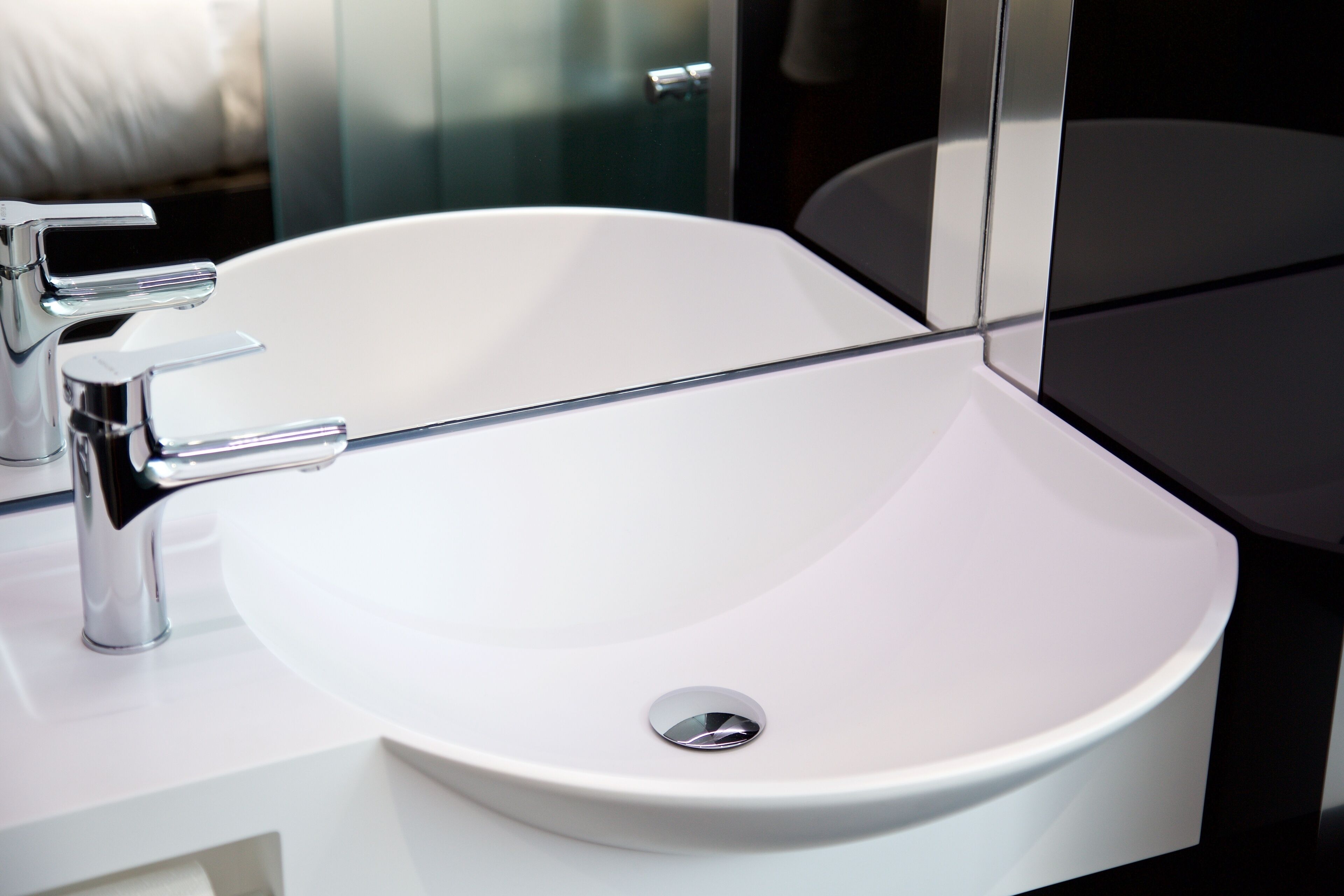 A white bathroom sink with chrome fixtures.