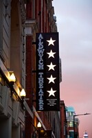 A theater marquee with stars and the name "ALDYCH THEATRE" along with "DAILY TELEGRAPH" and "SUN DAILY EXPRESS METRO" below.