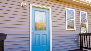 A house with a blue door, a porch, and two windows. - Stylish and NEW! Duke~Art Deco (Durham)