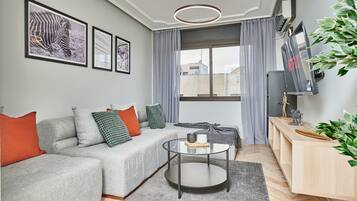 Basic Apartment, City View | Living area | 55-inch Smart TV with satellite channels, pay movies, heated floors