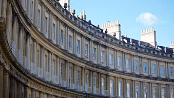 A classical building facade with symmetrical windows and ornate balustrades.