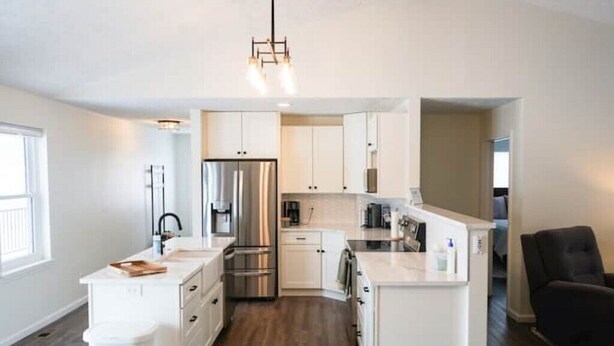 A modern kitchen with white cabinetry, stainless steel appliances, and a central island. - The Pond View House - quiet country getaway w/ hot tub
 (Leesburg)