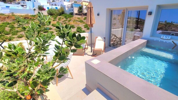 A modern outdoor pool area with a clear view of the surrounding neighborhood. - Vista Al Mar (Santorini)