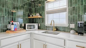 Fridge, microwave, coffee/tea maker, cookware/dishes/utensils