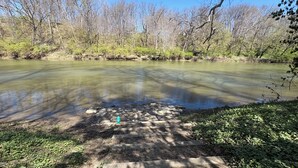 A river with a stone path leading to a dock.